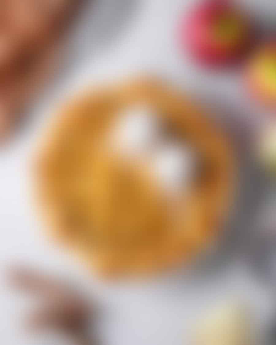 Freshly baked vegan apple pie on a wooden table